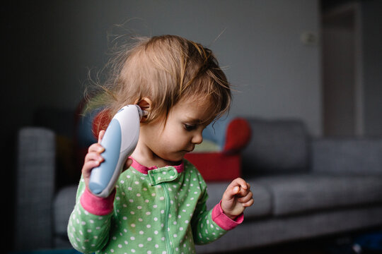 Toddler tries to take her own temperature