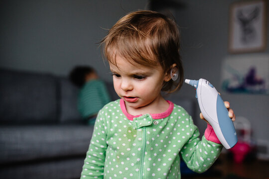 Toddler tries to take her own temperature