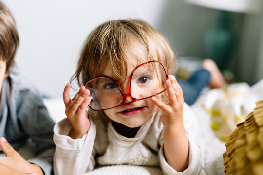 toddler wears glasses upside down 