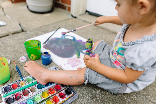Boy shows off canvas painting