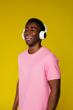 Studio portrait of man having fun in colored wall