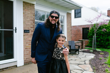 Father and Daughter pose for photos before dance