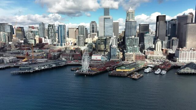 Seattle Waterfront and Cityscape Skyline. Aerial View of Great Wheel and Downtown Skyscrapers, Establishing Drone Shot