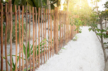 Reed fence on the beach. An old reed fence on the street near the country house.White sand