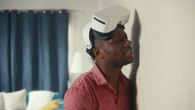 Angry multi ethnic men in VR headsets hit the wall with hands, scream at each other through thin walls. Neighbours quarrel. Apartment without sound insulation. Concept of neighbourhood and lifestyle.
