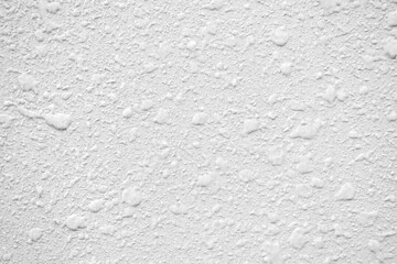 White stucco wall texture background.  Uneven plaster wall surface background. 