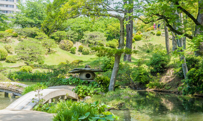 Landscape of footbridge over lake at Shukkeien Gardens in Hiroshima.