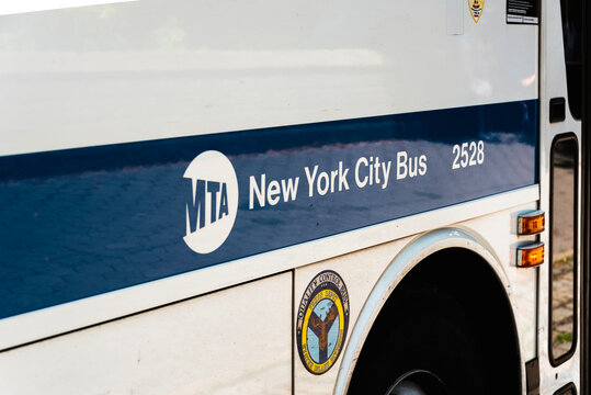 MTA logo on a blue and white color omnibus in NYC. Taken on May 2023.