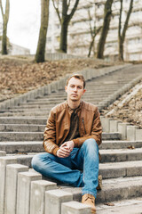 Obraz premium portrait of a young blond man in a brown leather jacket