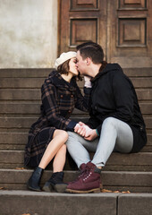 young man and woman kissing during a romantic date in autumn