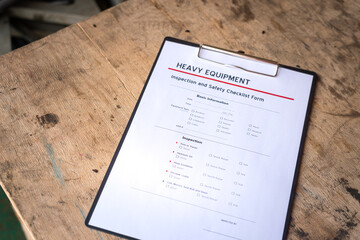 Heavy equipment checklist form using for inspect the condition of equipment before using. Industrial equipment object. Close-up and selective focus.