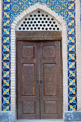 Fototapeta na wymiar closed door in a wall of different pattern
