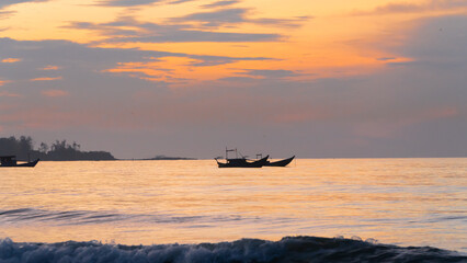 Landscape silhouette fishing boat is anchored in the sea at dawn. Seascape at sunrise and sunset,