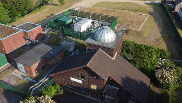 Aerial descending view Pex hill Leighton observatory silver dome rooftop on hilltop farmland at sunrise