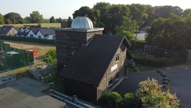 Aerial view Pex hill Leighton observatory rising to silver dome rooftop on hilltop farmland at sunrise