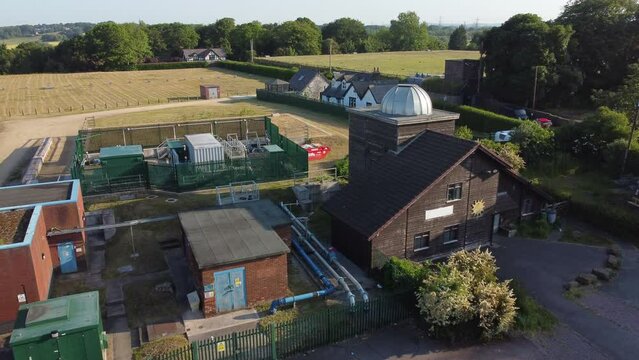 Aerial view Pex hill Leighton observatory silver dome rooftop on hilltop farmland at sunrise, slow push in