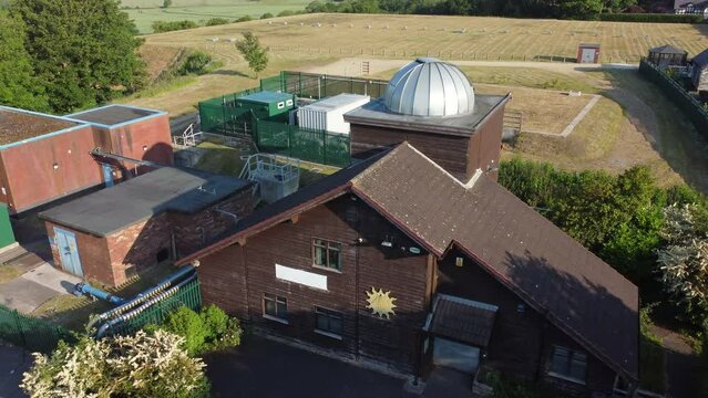 Establishing aerial view Pex hill Leighton observatory silver dome rooftop on hilltop farmland at sunrise
