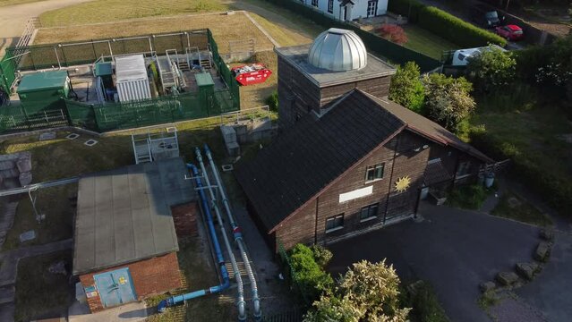 Aerial view Pex hill Leighton observatory silver dome rooftop on hilltop farmland at sunrise, rising tilt down