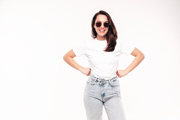 Young beautiful woman. Trendy carefree model in casual summer T-shirt and blue jeans. Positive female isolated on white in studio. Cheerful and happy. Copy space, mockup. In sunglasses