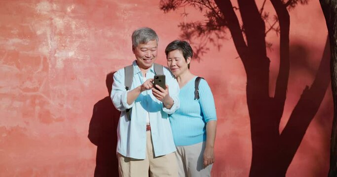 elderly couple use mobile traveling