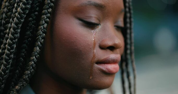 Close-up of a pretty young African woman feeling upset and crying desperately. 