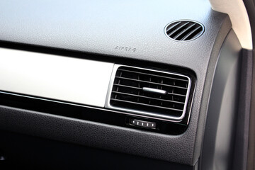 Modern car passenger airbag. Glove compartment in auto interior. Detail of new modern car interior. Black leather interior.