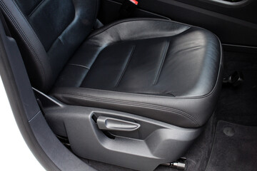 Modern luxury car black leather with alcantara interior. Part of black leather car seat. Interior of prestige car. Leather seats isolated. Adjustable car seat position.