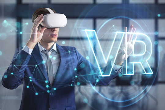 Virtual reality concept with man in VR glasses and VR sign hologram