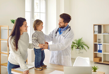 Family at the doctor's office. Young mother and her child visiting their pediatrician at the...