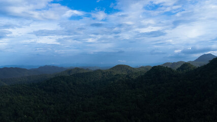 Fototapeta premium Green mountains and beautiful clouds under blue sky. Beautiful mountain landscape with bright sky.