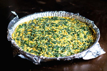 Pie with spinach and cheese. Raw vegetarian pie, cooking process.
