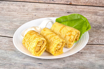Stuffed pancakes with cream sauce