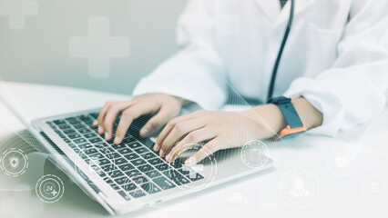 Close up of female doctor working with laptop computer. Medical and healthcare concept.