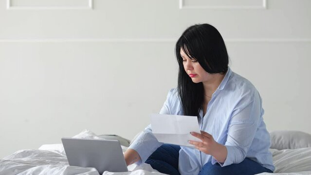 Woman Enters Information About Expensive Bills From Housing And Communal Services In Grey Laptop. Lady Types With Dissatisfied Expression