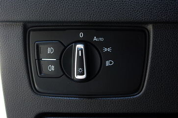 Close up of light control in car. Headlight switch, fog lights, automatic control of switching on...