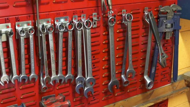 Slow motion shot of an engineer removing a spanner from a tool bench in an industry workshop in Stornoway on the Isle of Lewis, part of the Outer Hebrides of Scotland.