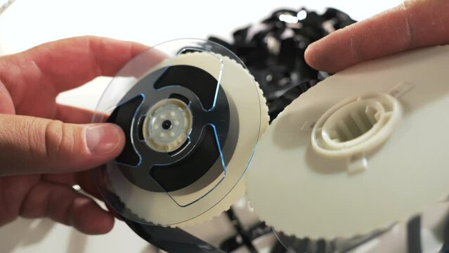 Reels with VHS tape inside the cassette