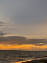 Naklejka na ściany i meble Sunset on the beach with the locals