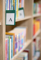 Book shelves with books and catalogue letter in library