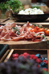 Luxury brunch in a hotel, italian food, prosciutto on a wooden plate