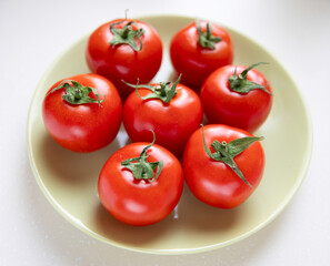 Group of whole tomatoes on plate