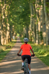 attractive senior woman cycling with her electric mountain bike in the city park of Stuttgart, Baden-Wuerttemberg, Germany