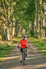 attractive senior woman cycling with her electric mountain bike in the city park of Stuttgart, Baden-Wuerttemberg, Germany