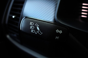 The light knob in the car. Multifunction Headlight Console Control Switch knob. Car interior with light switch. Headlight switch; Turn signal lever; Fog light switch.