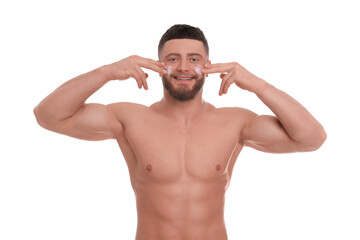 Fototapeta premium Handsome man applying cream onto his face on white background