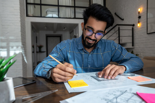 Bearded dark-haired man with papers looking involve dand interested