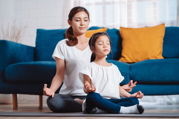 Mother and daughter exercising together happily at home. for flexibility build muscle strength, Sport workout training family together concept.