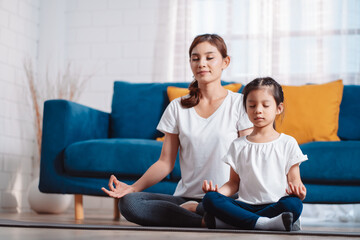Fototapeta na wymiar Mother and daughter exercising together happily at home. for flexibility build muscle strength, Sport workout training family together concept.
