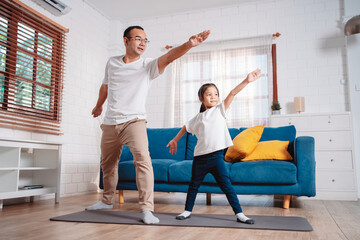 Father and daughter exercising together happily at home. for flexibility build muscle strength, Sport workout training family together concept.