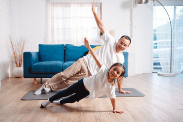 Fototapeta na wymiar Father and daughter exercising together happily at home. for flexibility build muscle strength, Sport workout training family together concept.